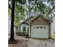 Home exterior with one car garage, bay window, neutral paint color and mature landscaping at 1017 Red Hat Ln, Durham, NC 27713