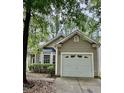 Home exterior with one car garage, bay window, neutral paint color and mature landscaping at 1017 Red Hat Ln, Durham, NC 27713