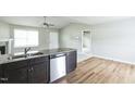Open concept kitchen with granite island, stainless steel appliances and light wood flooring at 103 Hampshire Pl, Kenly, NC 27542