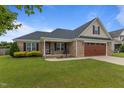 Beautiful brick home with well-maintained lawn and a two-car garage at 106 Lockwood Dr, Cameron, NC 28326