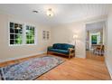 Cozy living room with hardwood floors, natural light, and comfortable seating at 1085 Bynum Rd, Pittsboro, NC 27312