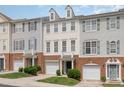 Townhouse exterior with vinyl siding, brick accents, a garage, and landscaped shrubbery at 109 Ruby Walk Dr, Morrisville, NC 27560
