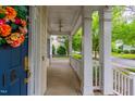 Covered front porch offers a cozy outdoor space, featuring a ceiling fan for added comfort and airflow at 116 Hamilton Hedge Pl, Cary, NC 27519