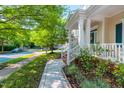 Charming front porch featuring white columns and railings, offering a glimpse of the peaceful neighborhood at 116 Hamilton Hedge Pl, Cary, NC 27519