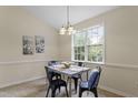 Bright dining area with a window, table, chairs, and neutral paint colors at 118 Setter Pt, Clayton, NC 27520