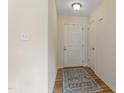 Welcoming entryway with a white door, hardwood floors, and neutral-colored walls at 118 Setter Pt, Clayton, NC 27520