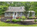 Charming single Gathering house with gray siding, black shutters and dormer windows at 1205 Elysian Way, Rougemont, NC 27572