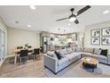 Spacious living room with dining area and modern kitchen with gray cabinetry and stainless steel appliances at 124 Twin Oaks Pl, Cary, NC 27511