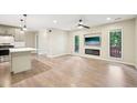 Bright living room featuring modern fixtures, fireplace, new floors and lots of natural light at 124 Twin Oaks Pl, Cary, NC 27511