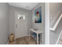 Inviting foyer featuring a decorative rug, table with decor, and a stairway at 150 Teal Dr, Youngsville, NC 27596