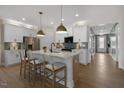 Modern kitchen with white cabinets, island with seating, and stainless steel appliances at 158 Vaughan Farms Drive Dr, Angier, NC 27501