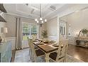 Traditional dining room featuring tray ceiling, chandelier, wainscotting, and hardwood floors at 187 Farrah-Shea Way, Angier, NC 27501