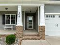 Inviting front porch features classic columns and brick accents at 206 Heart Pine Dr, Wendell, NC 27591