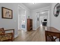Light-filled hallway showcasing beautiful flooring and access to multiple rooms at 206 Heart Pine Dr, Wendell, NC 27591