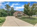 Lovely home with a long driveway, 2-car garage and well-maintained landscaping at 212 Fieldtrial Cir, Garner, NC 27529