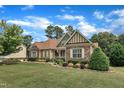 Attractive home featuring stone and siding accents, a green lawn, and lush landscaping at 212 Fieldtrial Cir, Garner, NC 27529