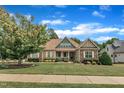 Beautiful home with a well-kept lawn, mature trees, and classic architectural details at 212 Fieldtrial Cir, Garner, NC 27529