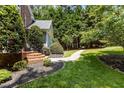 Pathway leading to a house with meticulous landscaping, including brick steps and dark mulch at 215 Collinson Dr, Chapel Hill, NC 27514