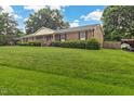 Expansive front lawn leading to a welcoming brick ranch home at 2423 Northern Bnd, Burlington, NC 27217
