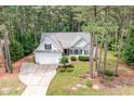Picturesque aerial view of the home, showcasing its position amidst lush greenery and mature trees at 25 Spicetree Ct, Youngsville, NC 27596