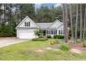 Well-maintained home featuring a two-car garage, charming landscaping, and a welcoming facade at 25 Spicetree Ct, Youngsville, NC 27596