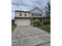 Inviting two-story home with a spacious driveway and well-maintained front yard at 2511 Dalmahoy Ln, Fuquay Varina, NC 27526