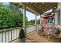 Inviting covered porch with comfortable seating, area rug and views of the neighborhood at 253 Tobacco Farm Way, Chapel Hill, NC 27516