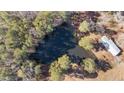 Breathtaking aerial showcasing private pond, and potential for a secluded retreat at 2630 Ponderosa Rd, Cameron, NC 28326