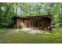 A modern house featuring a patio and surrounded by dense woodland trees at 2706 Montgomery St, Durham, NC 27705