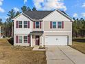 Charming two-story home with red shutters, a two-car garage, and a welcoming front entrance at 274 E Boulder Road Rd, Henderson, NC 27537