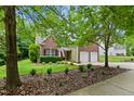 Charming two-story home with brick and siding, complemented by a well-maintained lawn and landscaping at 2801 Margots, Wake Forest, NC 27587