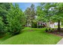 Landscaped front yard, mature trees, and a charming brick home with a two-car garage at 2801 Margots, Wake Forest, NC 27587