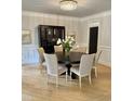 Elegant dining room featuring a round table with seating for six under a modern chandelier at 300 Bordeaux Ln, Cary, NC 27511