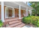 Inviting front porch with brick steps and columns leading to the beautiful front door at 300 Bordeaux Ln, Cary, NC 27511