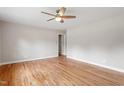 Bright living room with hardwood floors, a ceiling fan, and neutral paint at 3325 Old Buffaloe Rd, Raleigh, NC 27604