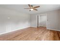 Living room featuring hardwood floors, a ceiling fan, and access to other rooms at 3325 Old Buffaloe Rd, Raleigh, NC 27604