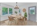 Cozy dining area with modern light fixture, seating for four, and view to outside at 460 Bunn Elementary School Rd, Bunn, NC 27508