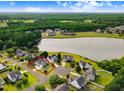 Aerial view of a house with a view of a lake, surrounded by trees and other houses at 479 Manchester Trail, Clayton, NC 27527