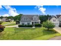 Charming home featuring a large front lawn, mature landscaping, and dormer windows at 479 Manchester Trail, Clayton, NC 27527