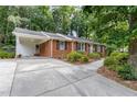 Beautiful red brick home with a portico and a long concrete driveway lined with landscaping at 4808 Berini Dr, Durham, NC 27705