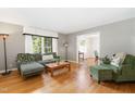 Inviting living room with hardwood floors, neutral walls, and large windows providing natural light at 4808 Berini Dr, Durham, NC 27705