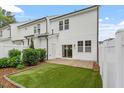 View of fenced backyard with manicured grass, patio and view of siding at 520 Kenton Mill Ct, Rolesville, NC 27571