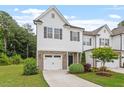 Charming two-story townhome featuring a stone accents, a single-car garage, and a well-manicured lawn at 520 Kenton Mill Ct, Rolesville, NC 27571