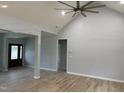 Spacious living room featuring an open floorplan, light gray walls, and stylish laminate flooring at 55 Leah Ln, Louisburg, NC 27549