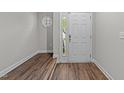 Bright entryway featuring hardwood floors and a white front door with a window for natural light at 5506 Cottonrose Ln, Raleigh, NC 27606
