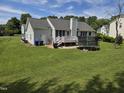 Expansive backyard with a deck, open lawn and trampoline at 5810 Stardust Ct, Durham, NC 27712