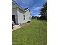 Spacious side yard featuring a well-maintained lawn and view of the house siding at 5810 Stardust Ct, Durham, NC 27712
