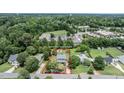 Aerial view showcasing the property's boundaries within a lush, green neighborhood at 601 Country Ln, Holly Springs, NC 27540