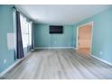 Bright living room featuring sleek floors, a neutral color scheme, and great natural light at 601 Country Ln, Holly Springs, NC 27540
