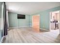 Bright living room featuring sleek floors, a neutral color scheme, and easy access to the kitchen at 601 Country Ln, Holly Springs, NC 27540